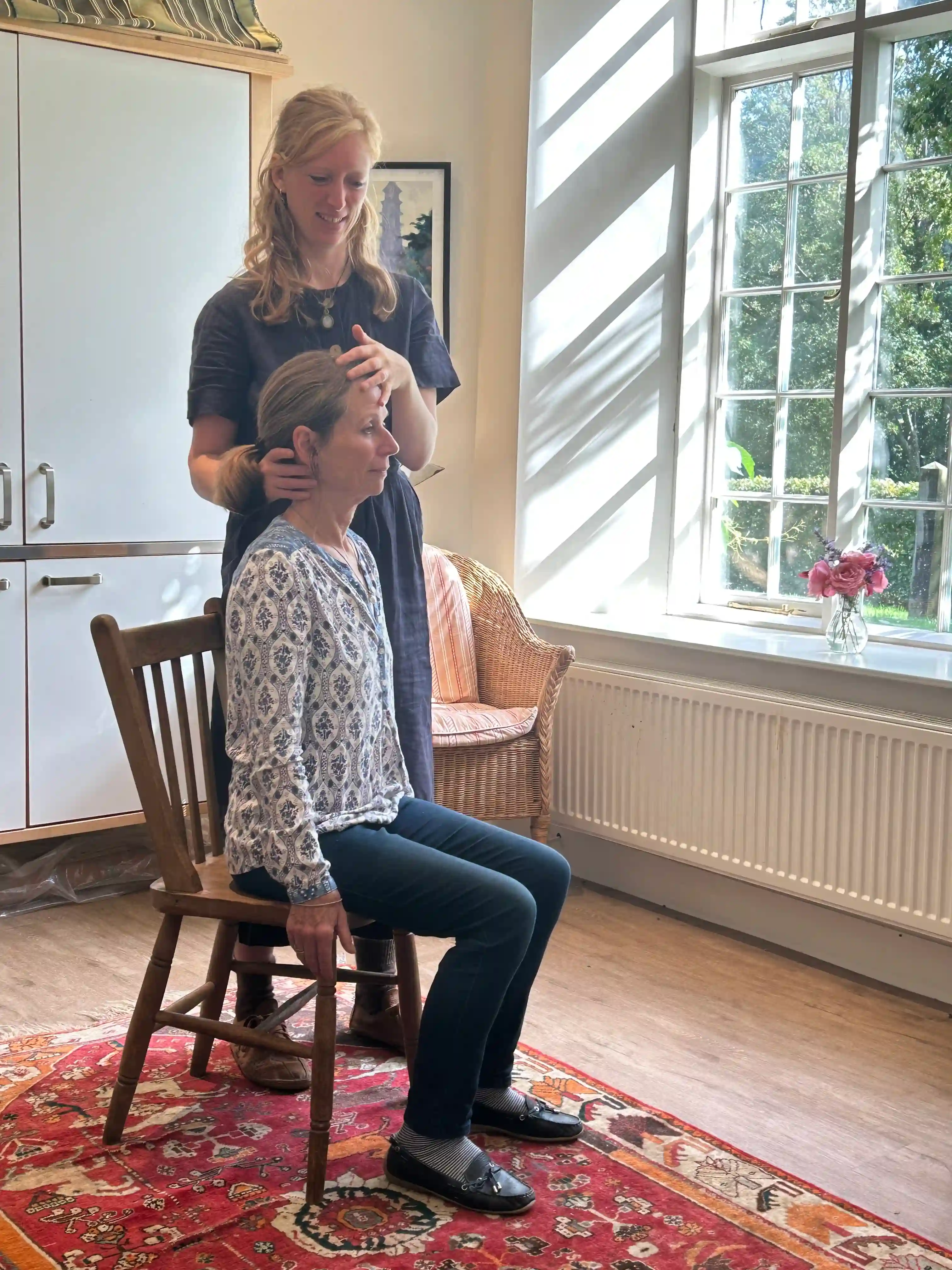 Clemmie Hopkinson providing hands-on Alexander Technique guidance, demonstrating therapeutic touch and patient care